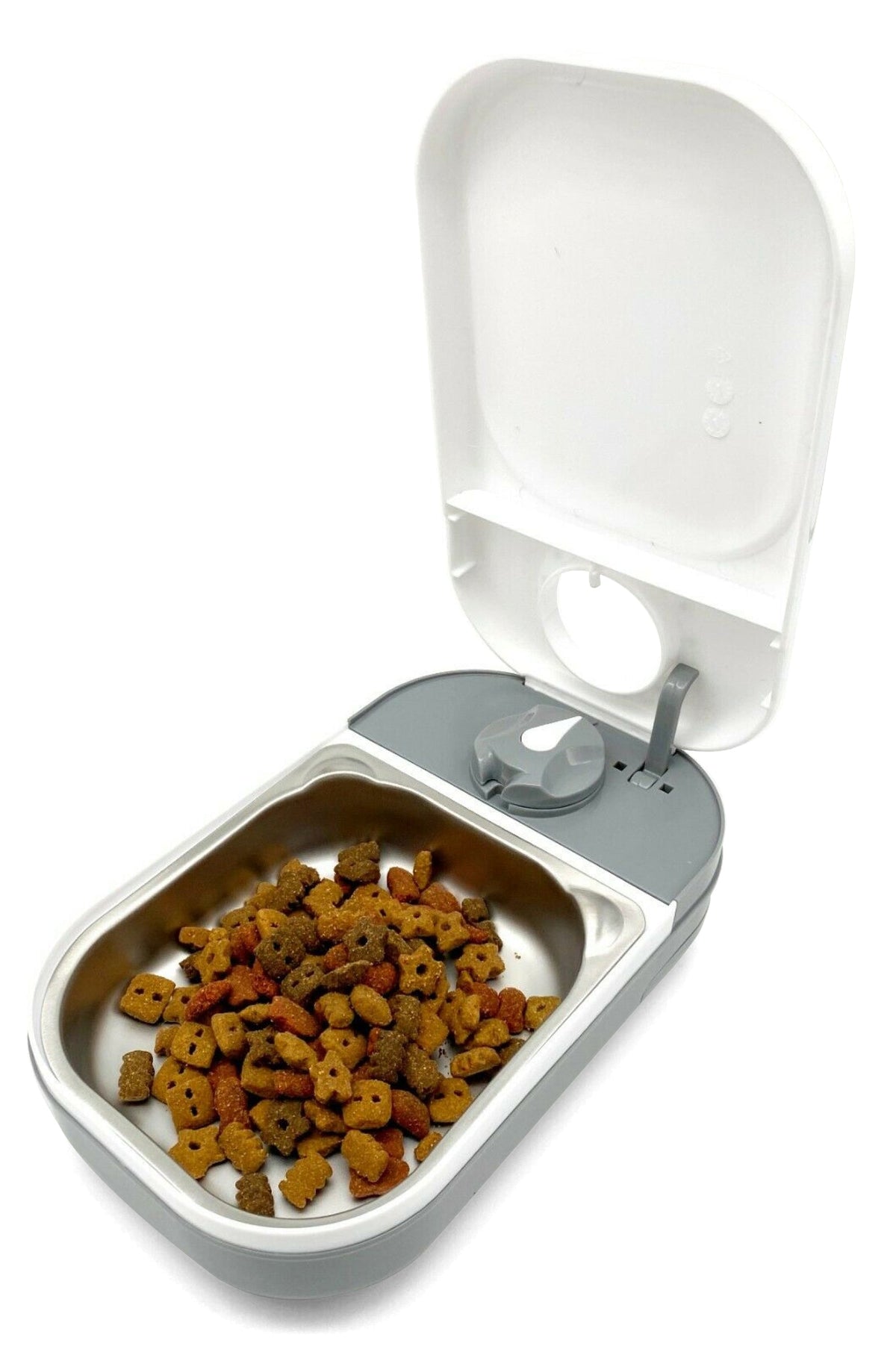 An automatic pet feeder with a white plastic housing and a stainless steel bowl filled with pet food on a white background.