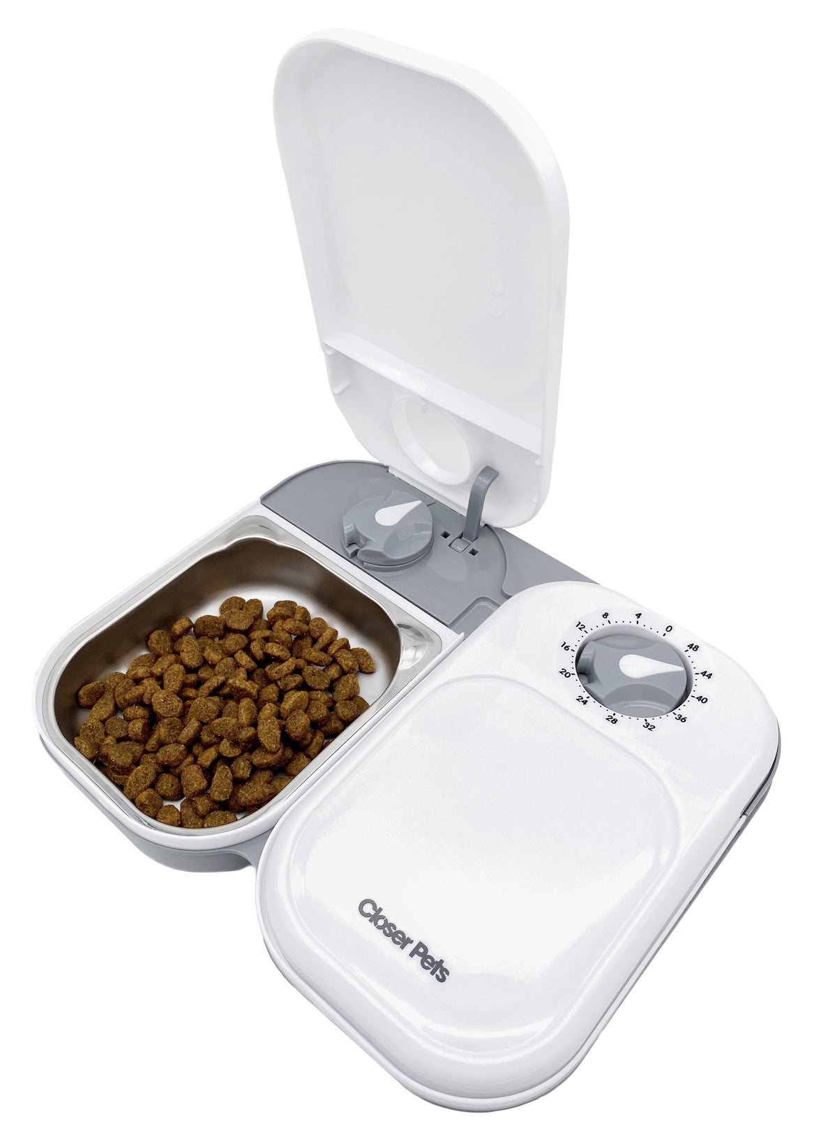 A white automatic pet feeder with a stainless steel bowl insert, showing one side open with cat food inside, and a timer dial on the front.