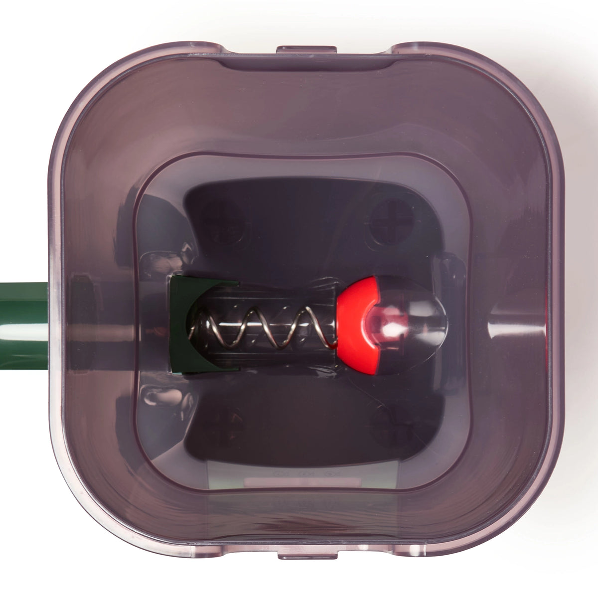 A top-down view of the inside of the automatic feeder for pond fish in green, against a white background. 