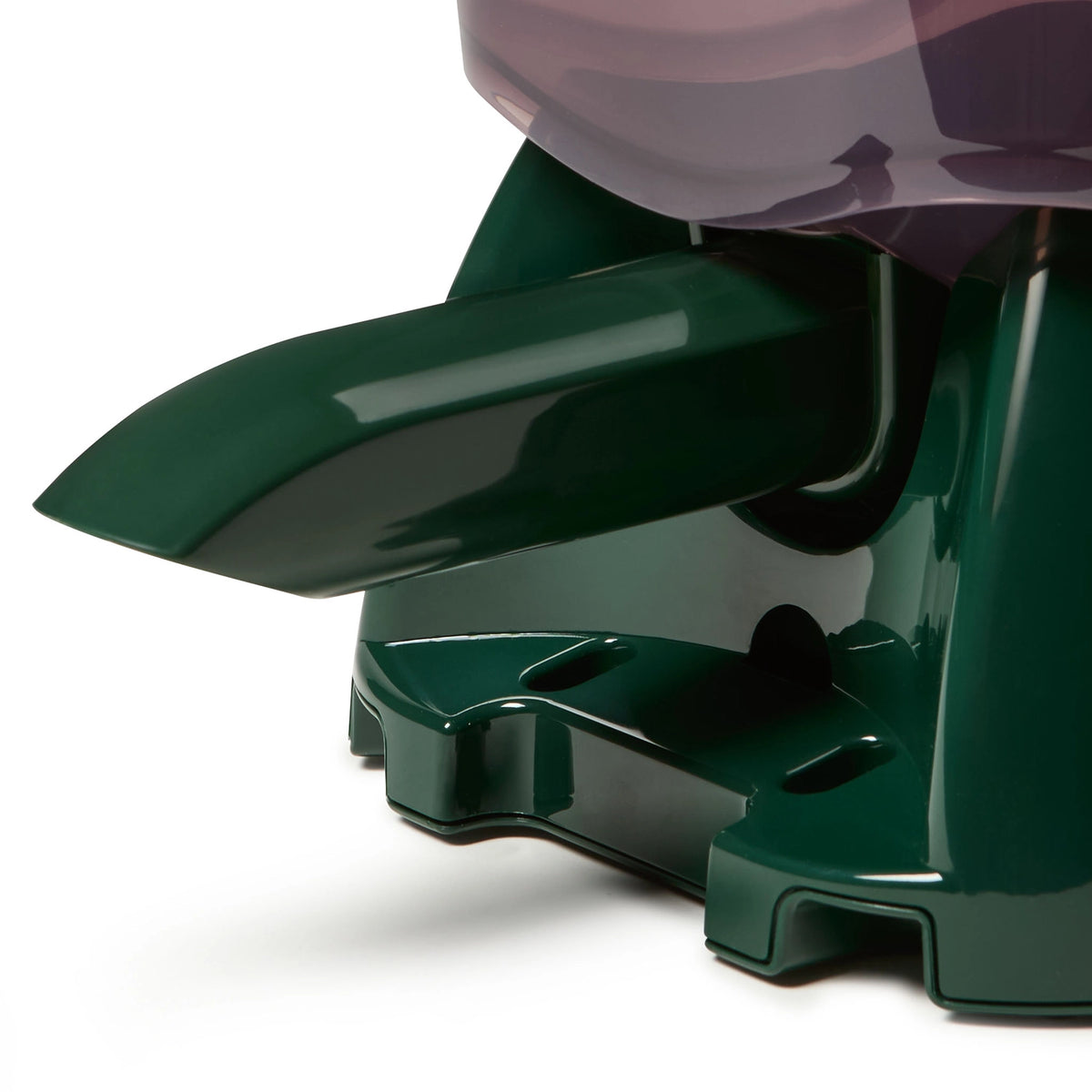 Close-up of the feeding spout on the green automatic pond fish feeder 