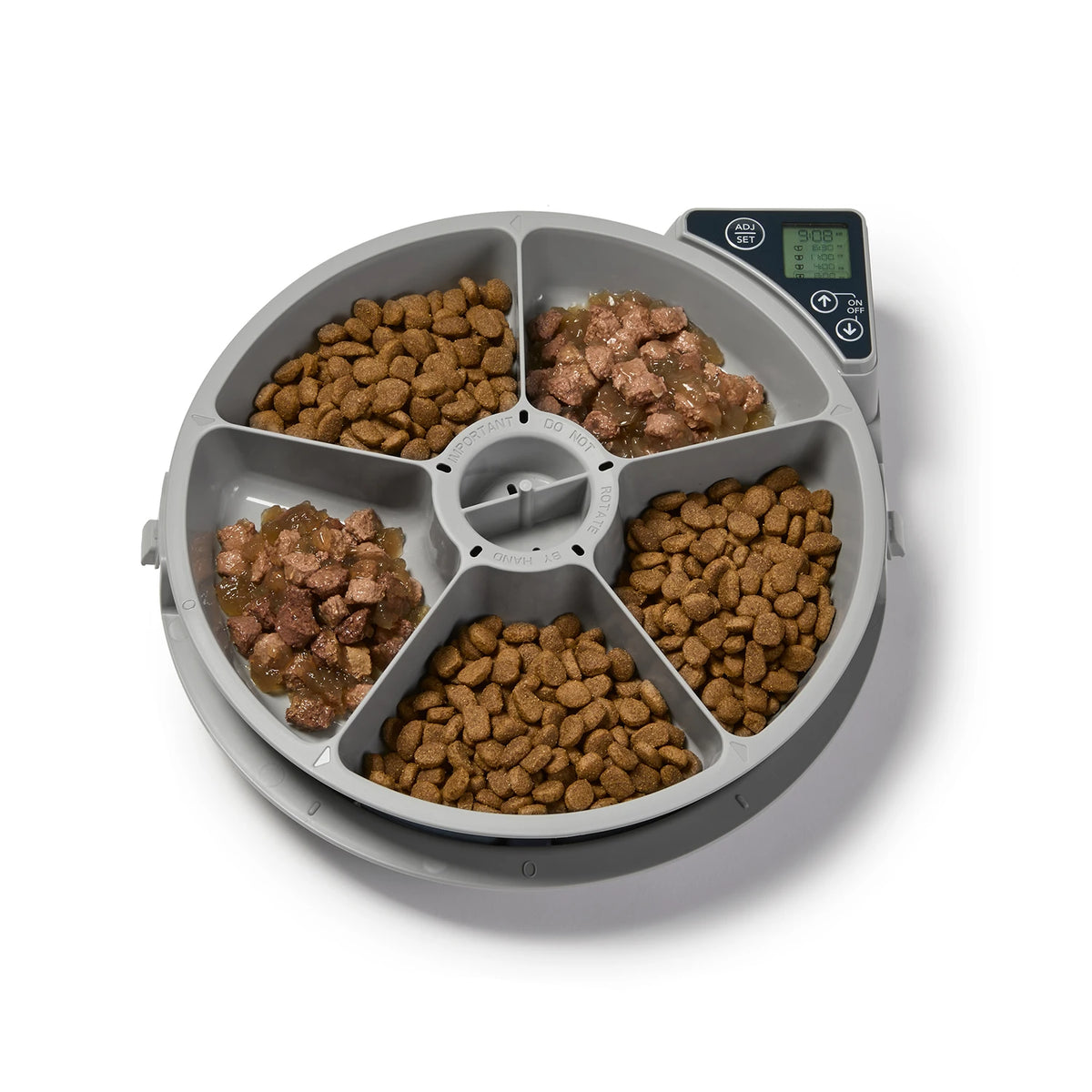 Pet food dispenser with compartments filled with kibble on a white background