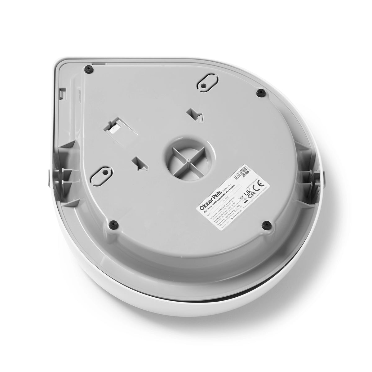 underside view of the electric automatic pet feeder with a label on a white background. 