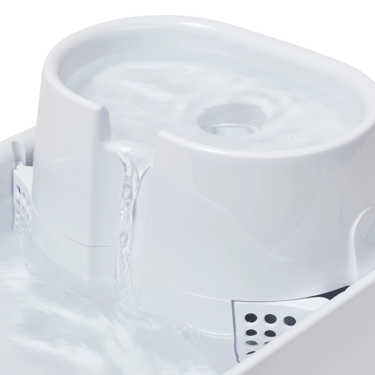 Close-up of water flowing down the fountain on a white background