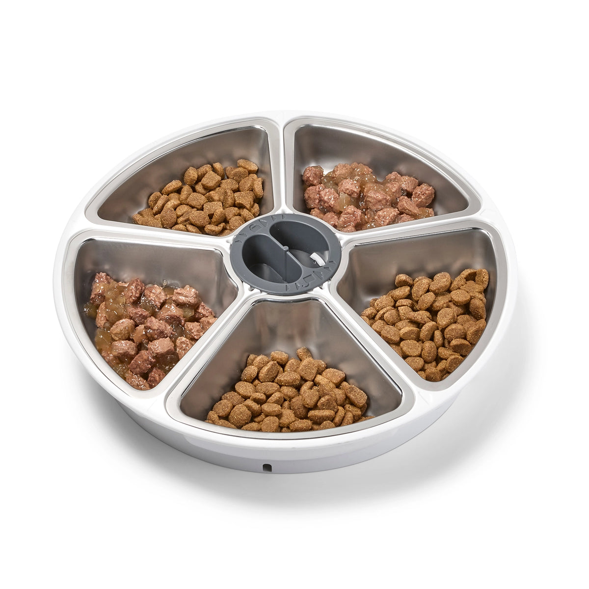 Pet food dish with multiple compartments filled with kibble on a white background